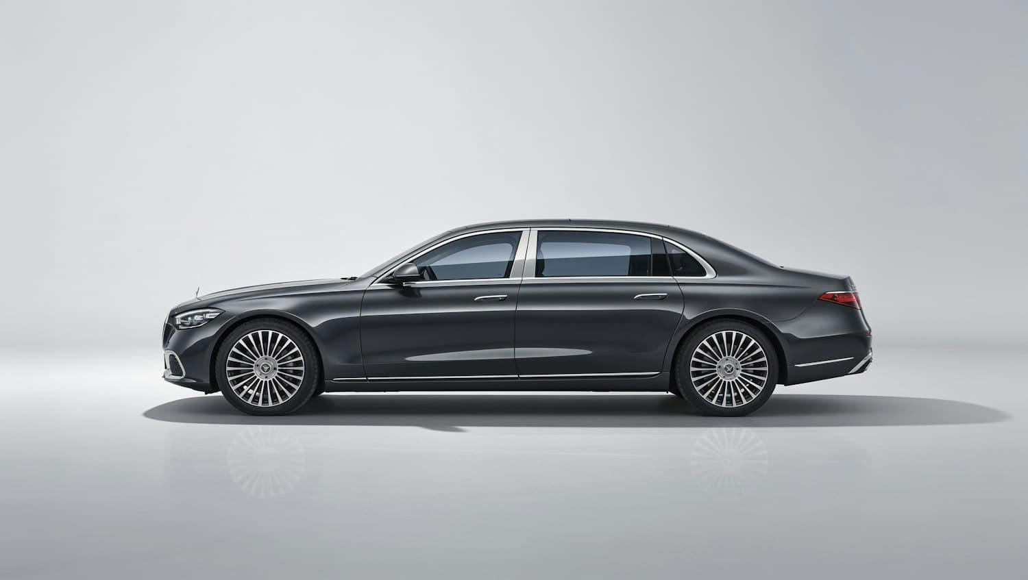 Bespoke Obsidian Rolls-Royce Ghost Black Badge with darkened chrome, shown in a clean minimal setting